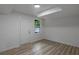 Well-lit bedroom with neutral walls, wood-look floors and a bright window at 6322 Phillips Creek Dr, Lithonia, GA 30058