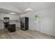 Bright kitchen area with modern floors, white cabinets, and a stainless steel refrigerator at 6322 Phillips Creek Dr, Lithonia, GA 30058