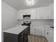 Bright kitchen featuring white cabinets, stainless steel appliances, and island with granite countertop at 6322 Phillips Creek Dr, Lithonia, GA 30058