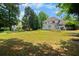 An expansive backyard view complete with deck, patio, and mature trees at 2820 Channing Way, Cumming, GA 30040