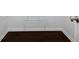 Dark wooden floor with metal shelf and white trim at 2820 Channing Way, Cumming, GA 30040