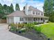 Charming two-story home featuring a welcoming front porch, well-manicured lawn, and vibrant flower beds at 2820 Channing Way, Cumming, GA 30040