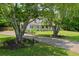 Charming home with mature trees, a long driveway, and a welcoming front porch, offering a serene setting at 2820 Channing Way, Cumming, GA 30040