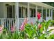 Inviting front porch with lush flowers in the foreground and a glimpse of the charming home in the background at 2820 Channing Way, Cumming, GA 30040
