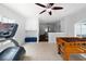 Bright game room with a foosball table, gym equipment, and access to other living spaces at 2820 Channing Way, Cumming, GA 30040