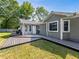 Backyard featuring a wooden deck, a gray house with white trim and a well-maintained lawn at 30 Court S, Ellenwood, GA 30294