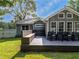 Backyard with a house, wooden deck, black chairs, and green grass at 30 Court S, Ellenwood, GA 30294
