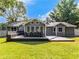 Backyard showcasing a house with a back deck, seating, and green lawn at 30 Court S, Ellenwood, GA 30294