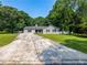 Inviting single-Gathering home featuring a neatly landscaped front yard and a covered carport at 30 Court S, Ellenwood, GA 30294