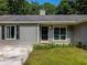 Close up of the gray home exterior, front door and manicured landscaping at 30 Court S, Ellenwood, GA 30294
