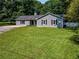 Well-maintained front yard with green lawn and charming exterior at 30 Court S, Ellenwood, GA 30294