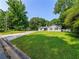 Traditional home with a large, lush front yard in a peaceful, tree-lined neighborhood at 30 Court S, Ellenwood, GA 30294