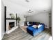 Bright and airy living room with a cozy fireplace and a stylish blue sectional at 30 Court S, Ellenwood, GA 30294