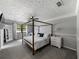 Spacious main bedroom featuring a four-post bed, ceiling fan, and neutral color palette at 30 Court S, Ellenwood, GA 30294