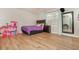 Bright bedroom with wood floors, natural light, and a decorative dollhouse adds charm to this inviting space at 365 Winding River Dr # E, Atlanta, GA 30350