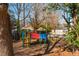 Colorful playground equipment surrounded by mature trees in the community at 365 Winding River Dr # E, Atlanta, GA 30350