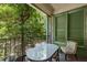Balcony view with a bistro table and chair, overlooking lush green trees at 124 Lafayette Ne Dr # 4, Atlanta, GA 30309