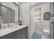 Clean bathroom featuring custom cabinets, a shower/tub combo and a window at 124 Lafayette Ne Dr # 4, Atlanta, GA 30309