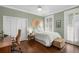 Serene bedroom featuring hardwood floors, closet and shuttered windows at 124 Lafayette Ne Dr # 4, Atlanta, GA 30309