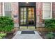 Elegant brick front door with glass paned doors, set in manicured landscaping at 124 Lafayette Ne Dr # 4, Atlanta, GA 30309
