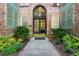 Charming brick building entrance featuring an arched doorway, double doors, and landscaped walkway at 124 Lafayette Ne Dr # 4, Atlanta, GA 30309