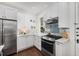 Bright kitchen with white cabinets, stainless steel appliances, and natural light from the window at 124 Lafayette Ne Dr # 4, Atlanta, GA 30309