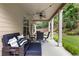 Relax on this covered back porch with ceiling fan, comfortable furniture and a backyard view at 1650 Walking Horse Trl, Cumming, GA 30041