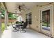 Outdoor dining on the covered back porch with string lights and a ceiling fan at 1650 Walking Horse Trl, Cumming, GA 30041