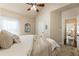 Bedroom with a ceiling fan, large bed, and a view into another bedroom at 1650 Walking Horse Trl, Cumming, GA 30041