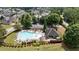 Community pool and clubhouse surrounded by lush greenery and trees at 1650 Walking Horse Trl, Cumming, GA 30041
