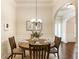 Cozy dining area featuring a round wood table and natural light at 1650 Walking Horse Trl, Cumming, GA 30041