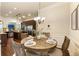 Open-concept dining area with a round table, neutral walls, and backyard views at 1650 Walking Horse Trl, Cumming, GA 30041