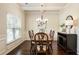 Cozy dining room with dark wood furniture, neutral walls and trimmed window at 1650 Walking Horse Trl, Cumming, GA 30041