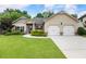 Inviting single-story home with manicured lawn and attached two-car garage at 1650 Walking Horse Trl, Cumming, GA 30041