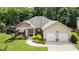 Charming home featuring a well-manicured front yard, inviting entrance, and a two-car garage, offering curb appeal at 1650 Walking Horse Trl, Cumming, GA 30041