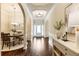 Open hallway with hardwood flooring, archways, and a view of the dining area at 1650 Walking Horse Trl, Cumming, GA 30041