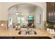 The kitchen granite counter overlooks the living room with stone fireplace and comfortable seating at 1650 Walking Horse Trl, Cumming, GA 30041