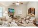 Comfortable living room seating area adjacent to the kitchen boasts a stone fireplace and media center at 1650 Walking Horse Trl, Cumming, GA 30041