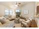 Inviting living room features a stone fireplace, television, and views into the kitchen at 1650 Walking Horse Trl, Cumming, GA 30041