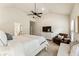Spacious main bedroom with a vaulted ceiling, ceiling fan, sitting area, and an ensuite bathroom at 1650 Walking Horse Trl, Cumming, GA 30041