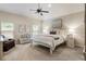 Serene main bedroom features large windows, soft carpeting, and a neutral color palette at 1650 Walking Horse Trl, Cumming, GA 30041