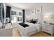 Bright bedroom with a large window, plush bedding, and stylish decor for a comfortable retreat at 230 New St # 2201-4, Decatur, GA 30030
