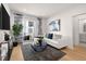 Bright living room with hardwood floors, a comfortable couch, and a balcony at 230 New St # 2201-4, Decatur, GA 30030