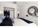 Comfortable main bedroom featuring a stylish accent mirror and closet space at 230 New St # 2201-4, Decatur, GA 30030