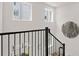Bright staircase features dark railings and a decorative wall hanging at 230 New St # 2201-4, Decatur, GA 30030
