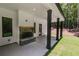 A spacious covered patio features dark pillars and an outdoor stone fireplace at 48 Paschal St, Temple, GA 30179