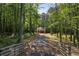 View of the home down a long driveway and wooded lot at 48 Paschal St, Temple, GA 30179