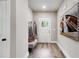 Bright entryway with coat rack, bench, wood floors, and boat art at 48 Paschal St, Temple, GA 30179