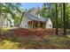 Exterior view of a new home with beige siding and an unfinished yard surrounded by trees at 48 Paschal St, Temple, GA 30179