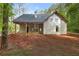 Exterior view of a new home with beige siding and an unfinished yard surrounded by trees at 48 Paschal St, Temple, GA 30179